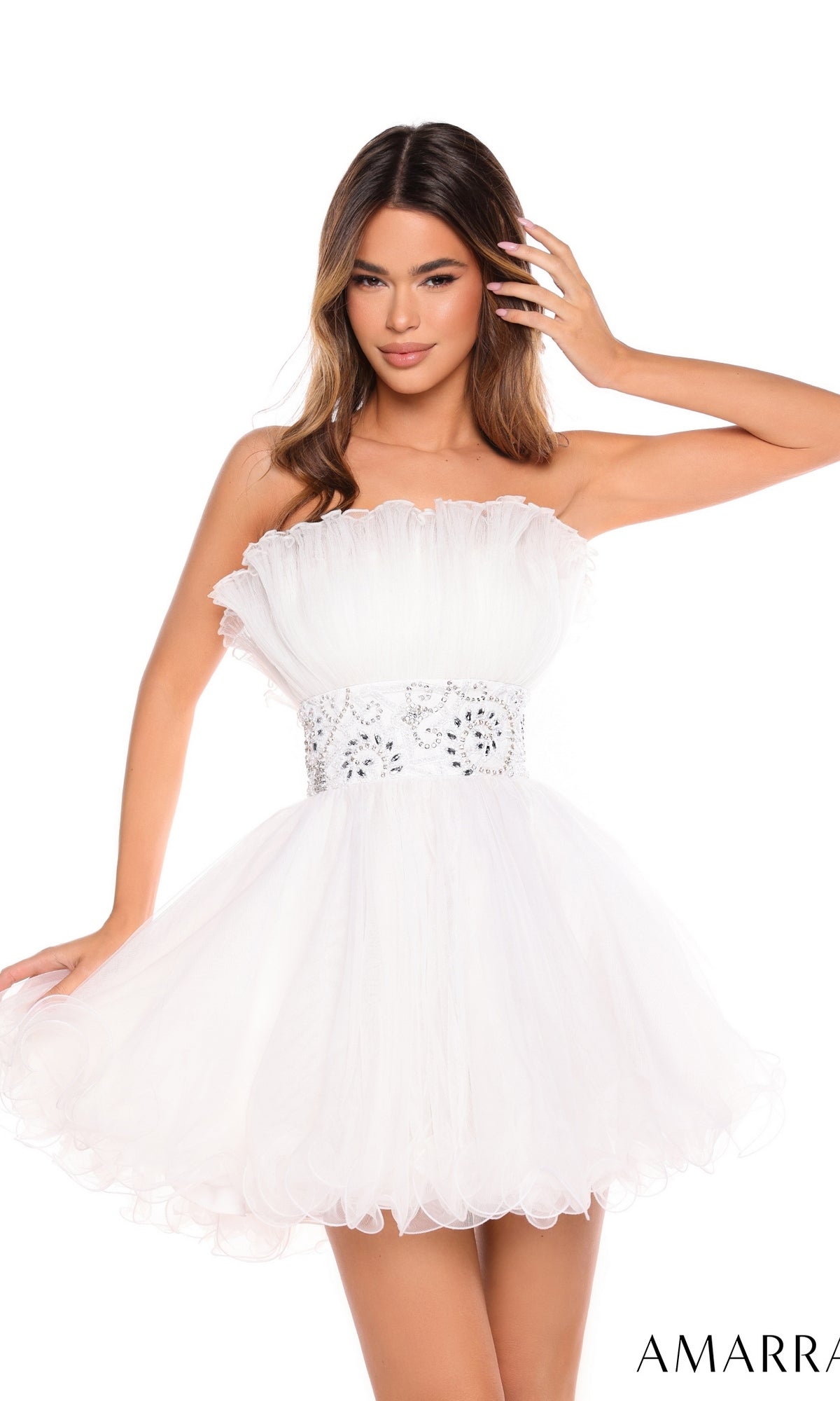 A woman wears the Short Homecoming Dress 88038 by Amarra, featuring a strapless design, ruffled bodice, and beaded waist, posing with one hand in her hair. The word “AMARRA” appears in the bottom right corner.